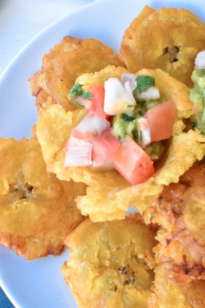 patacones topped with a salsa filling